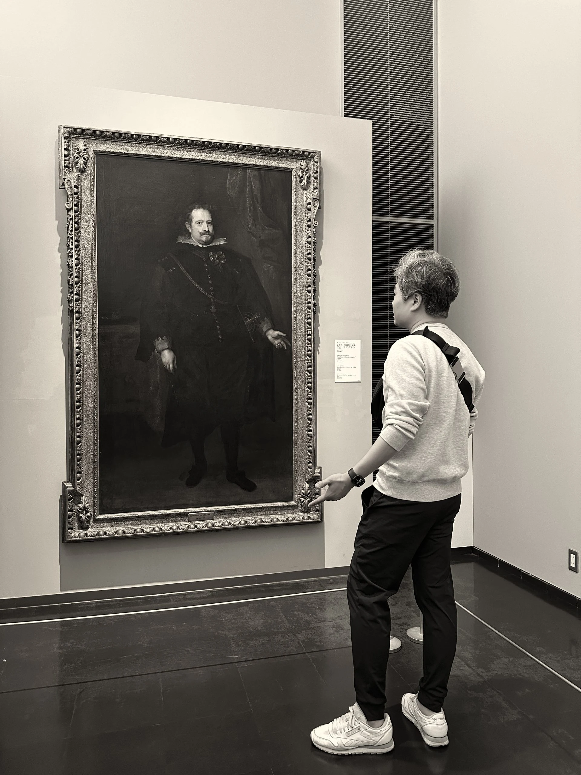 Eric Luke viewing a classical portrait in a gallery